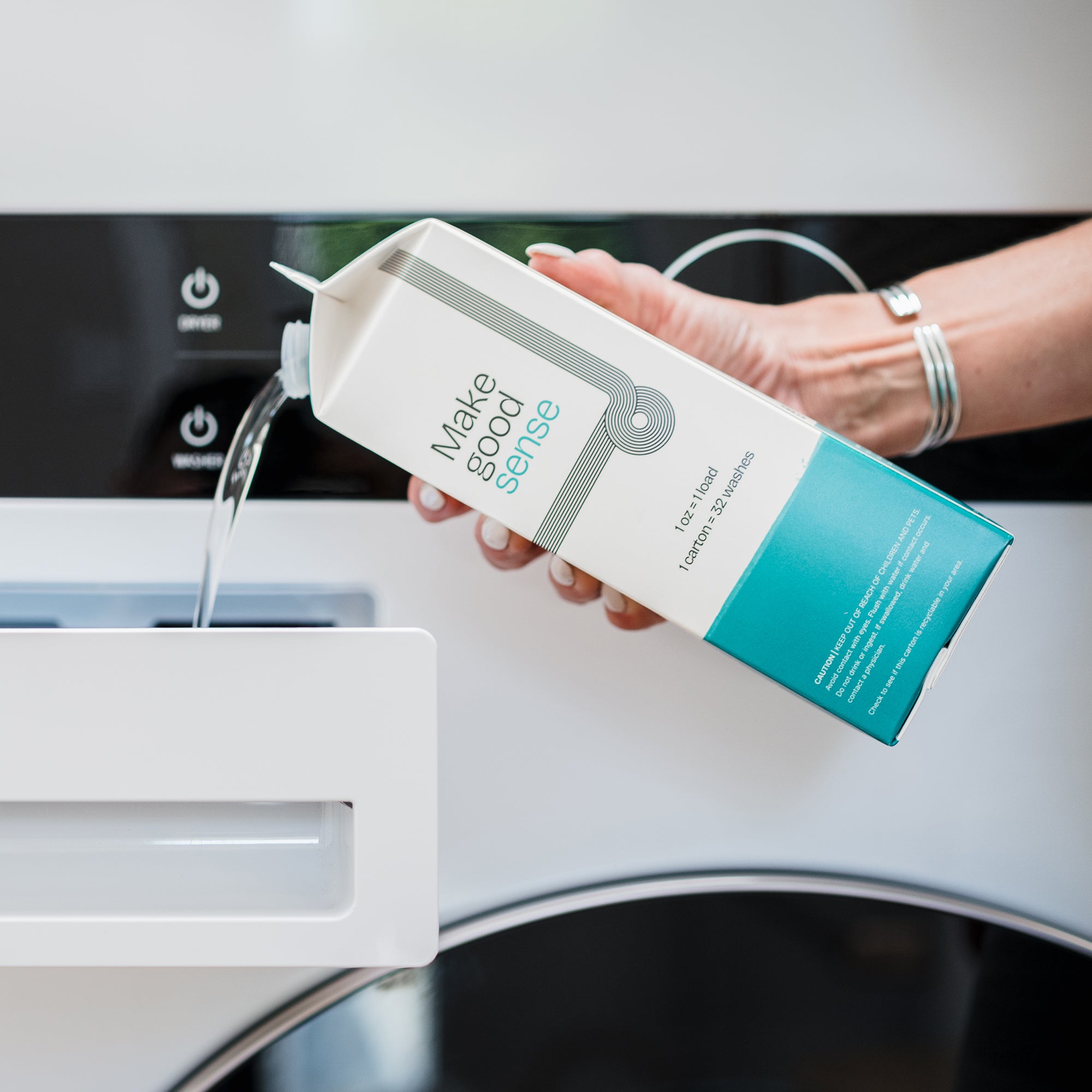 Side View of Salt Air Natural Laundry Soap. 32 ounces. Plastic-free packaging. Laundry Soap being poured into washing machine.