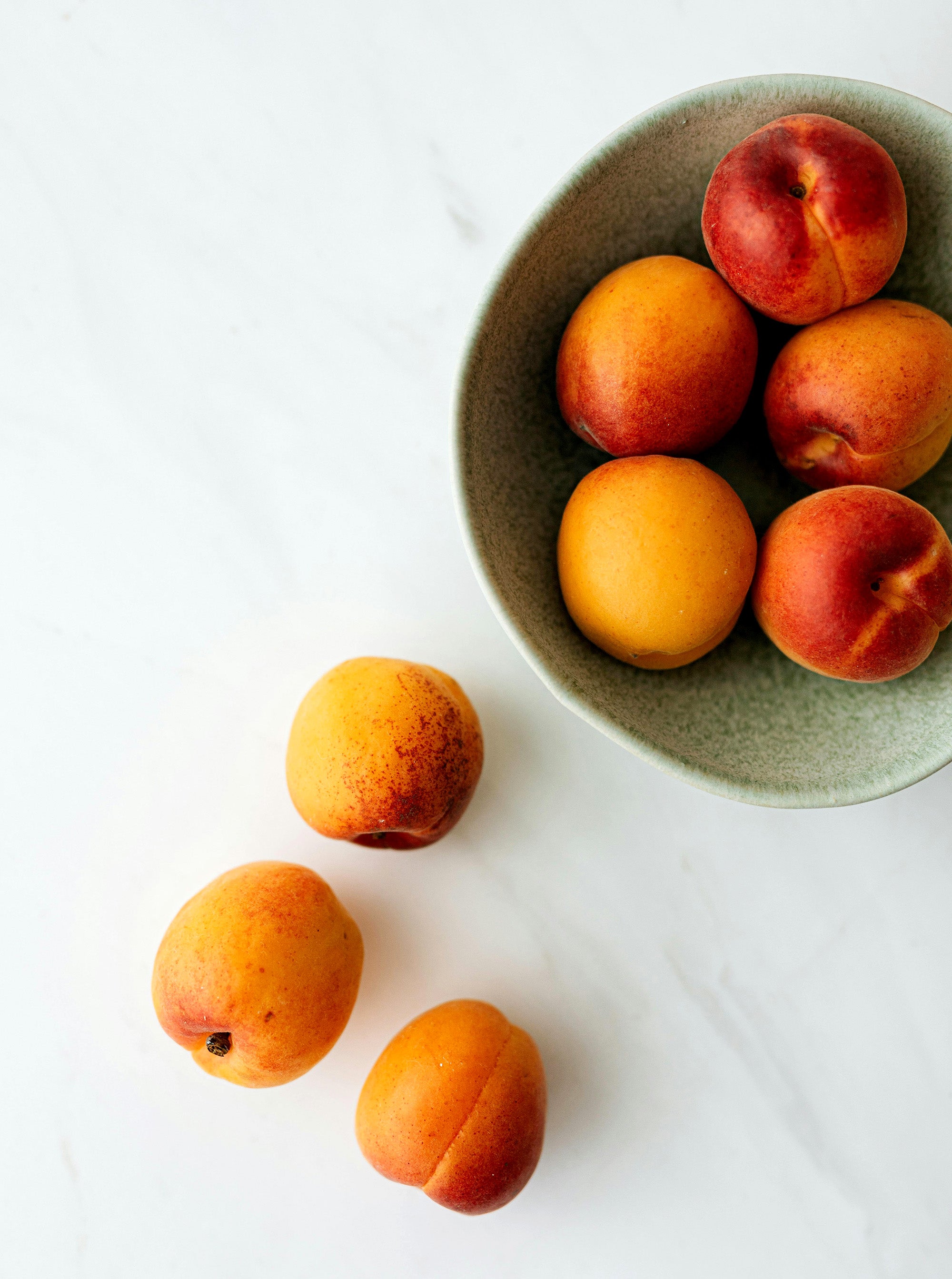 Image of fruit in a bowl and around bowl.