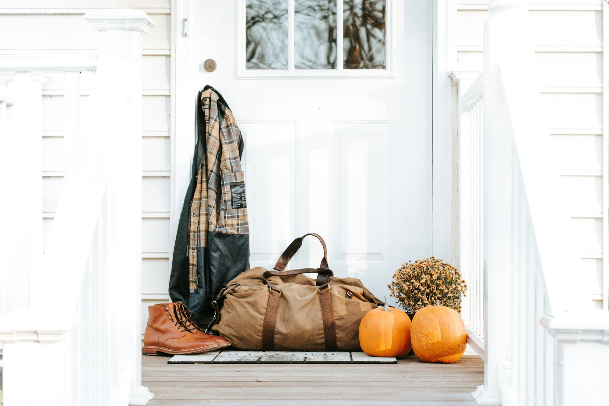 Fall clothing and essentials on a porch, how to wash fall clothing, wash denim, wash flannels, wash wool, wash blanket