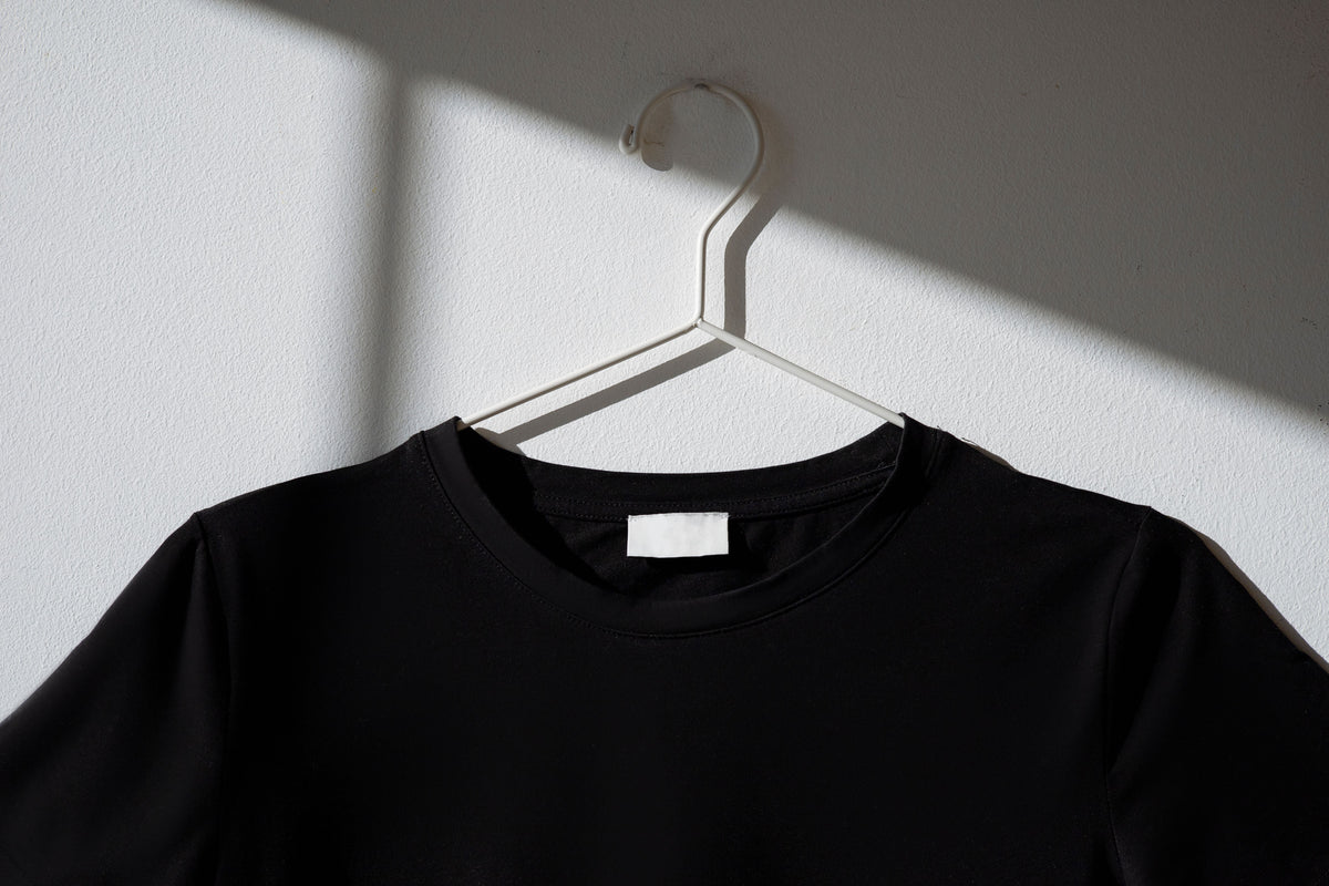 black t-shirt on a hangar, keep your black and dark clothes darker for longer