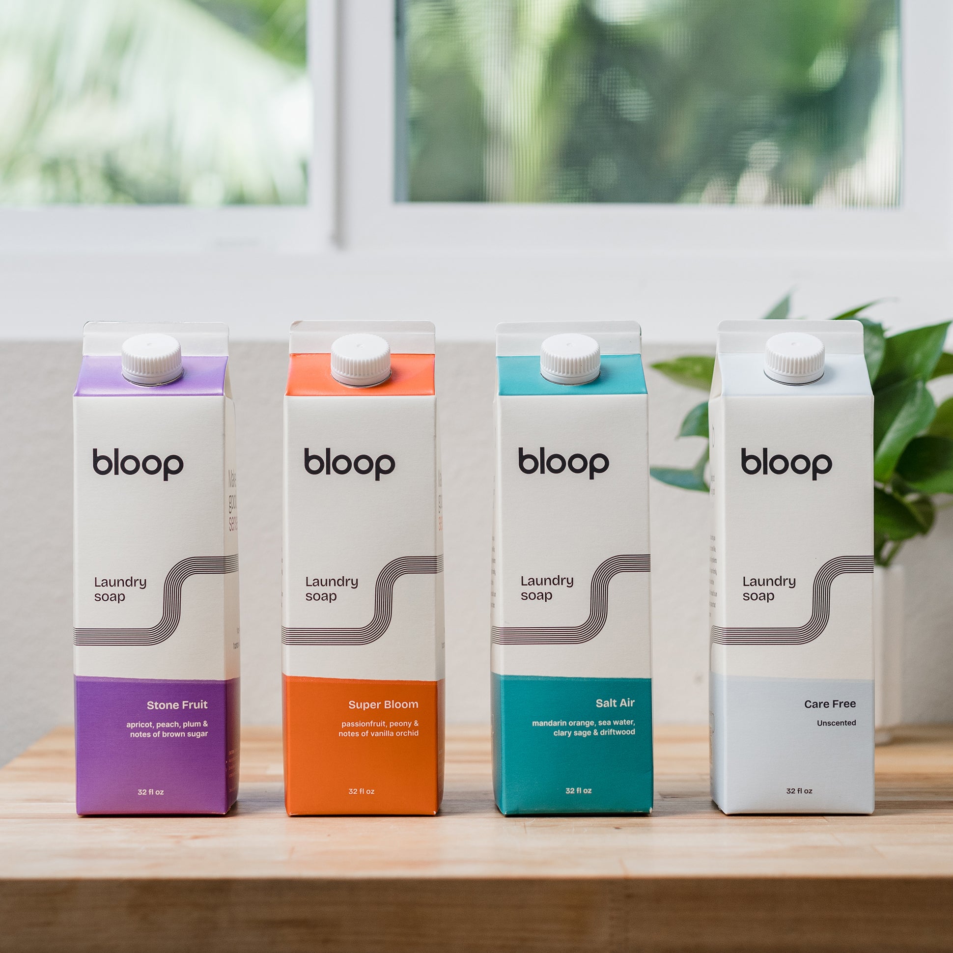 Front view of Stone Fruit, Super Bloom, Salt Air, and Care Free Bloop Laundry Soap. 32 ounce cartons. Plastic-free and environmentally friendly.